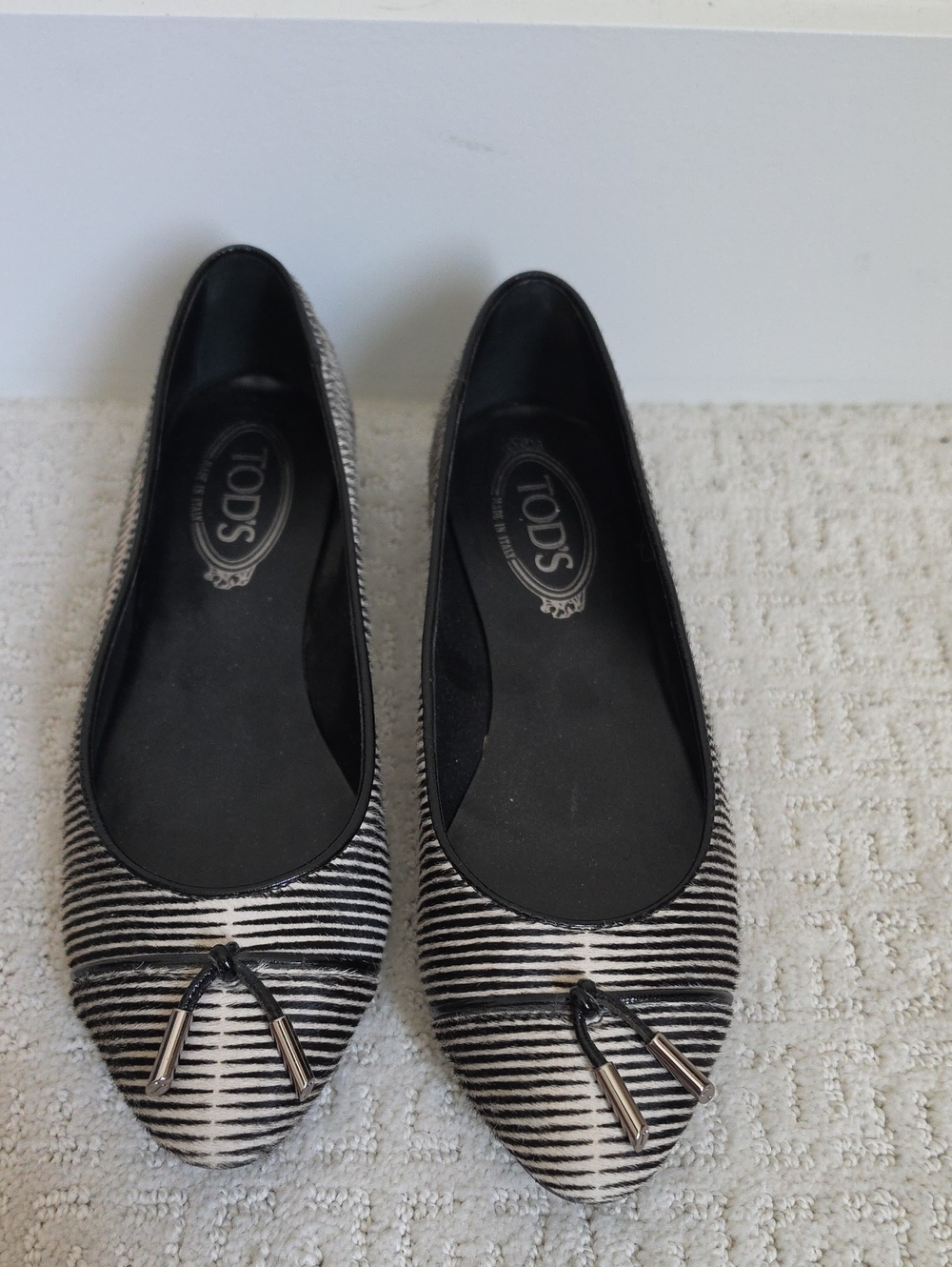 TOD'S Black and White Striped Pointed-Toe Ballet Flats with Tassel Accent